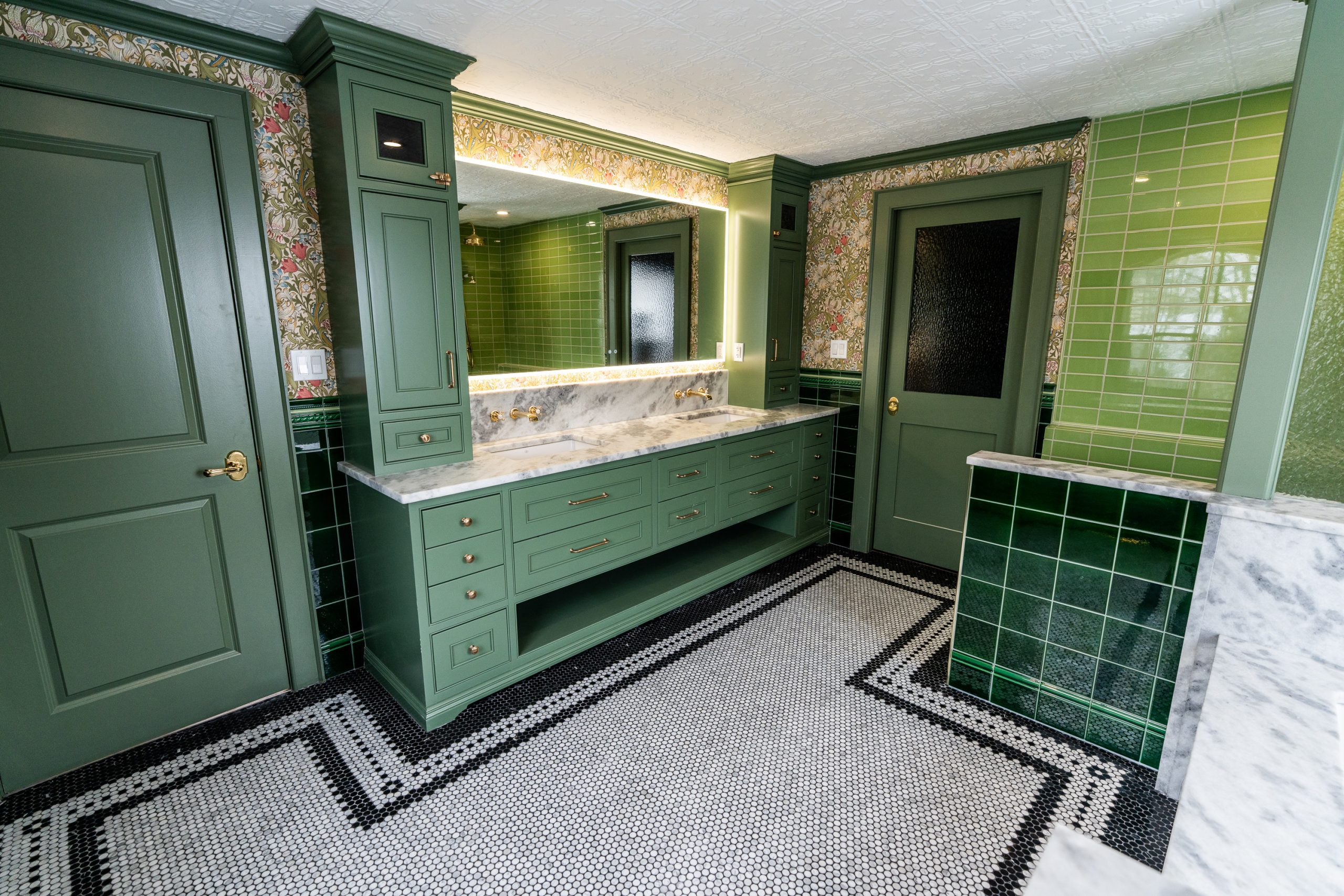 Custom curbless shower with green subway tile and marble penny floor in Waterloo Region bathroom renovation