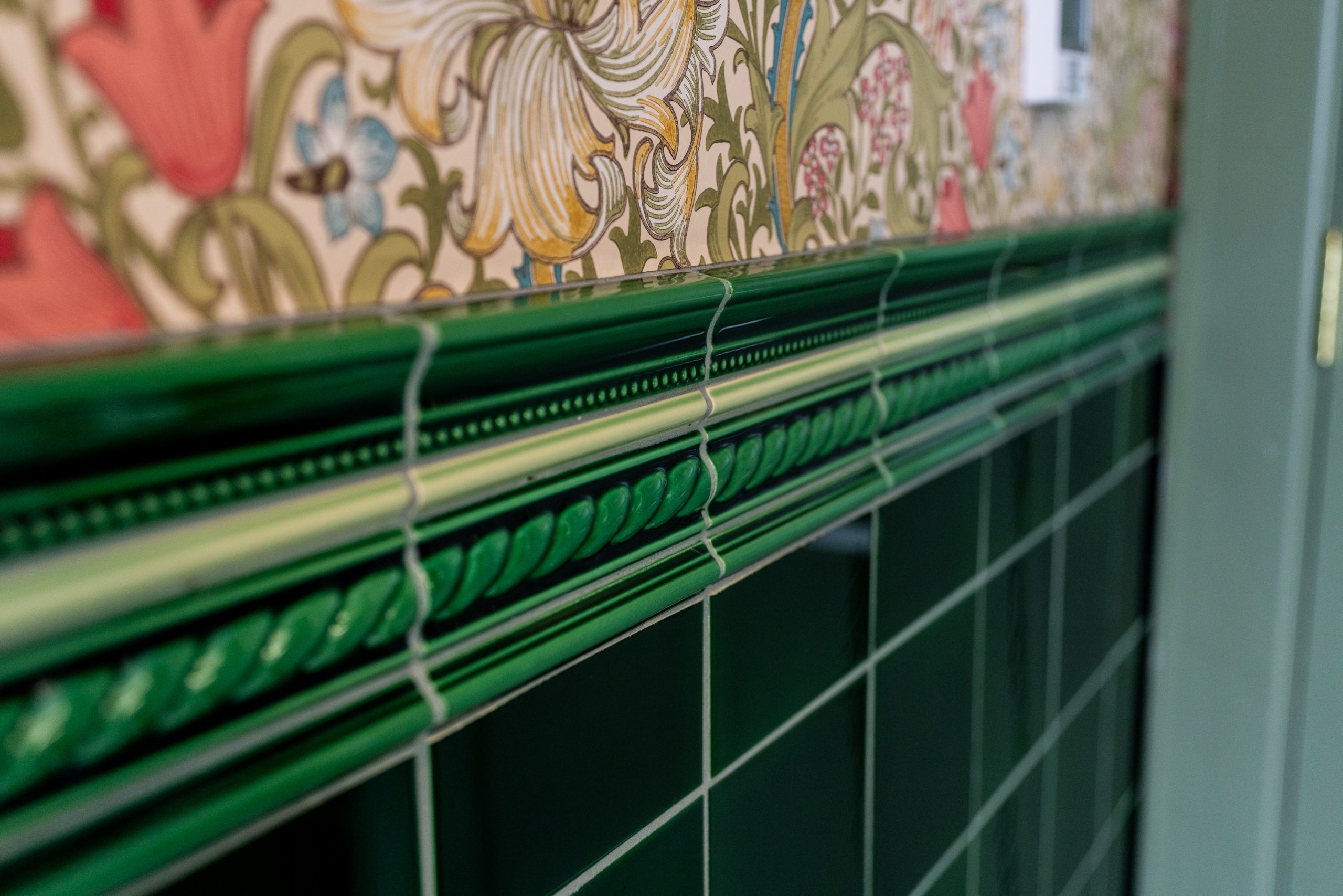 Custom curbless shower with green subway tile and marble penny floor in Waterloo Region bathroom renovation