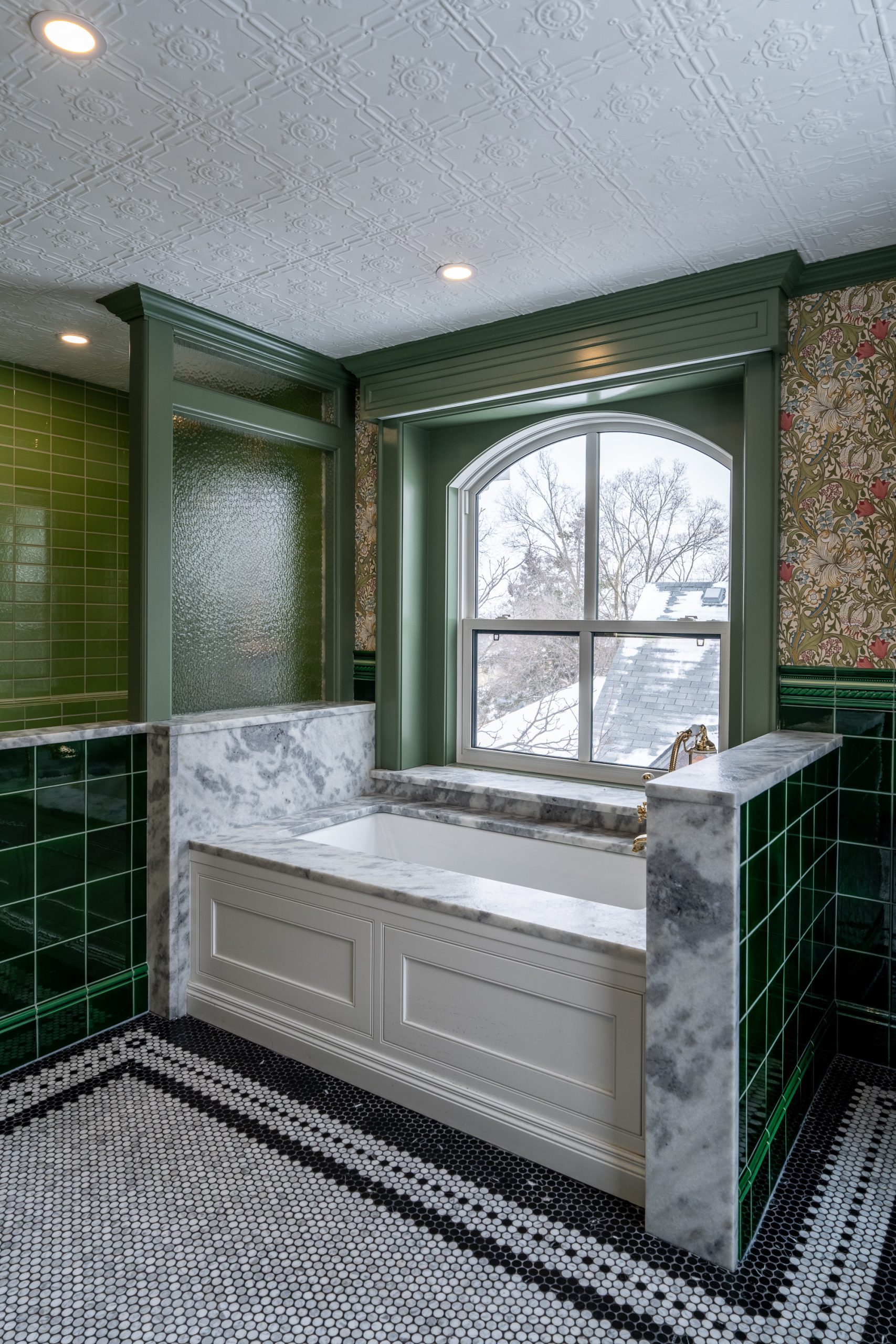 Custom curbless shower with green subway tile and marble penny floor in Waterloo Region bathroom renovation